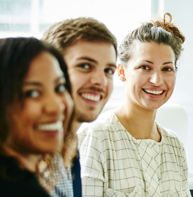 カメラに笑顔を向ける3人のネットワークエンジニア