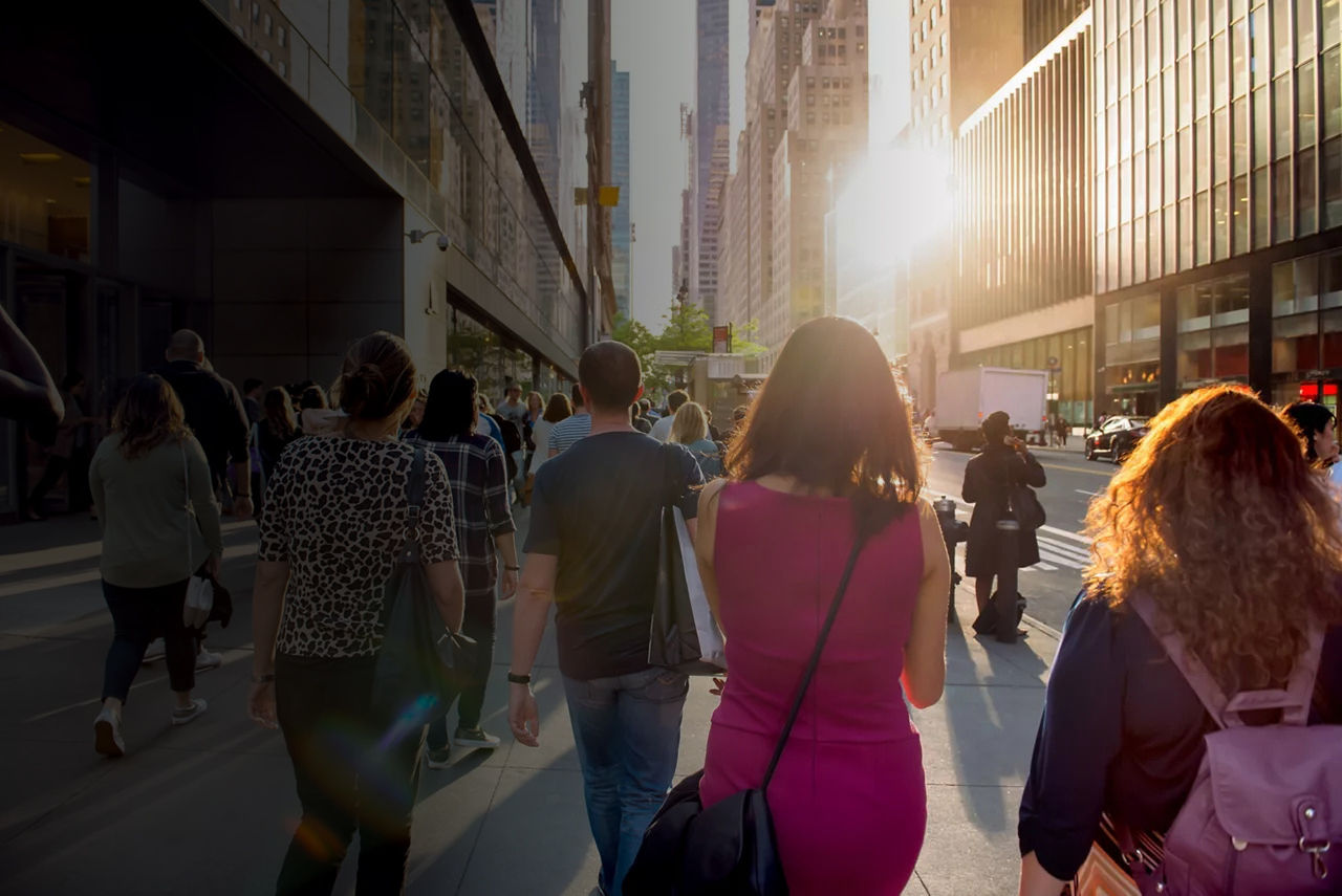 People walking on the sidewalk in a city