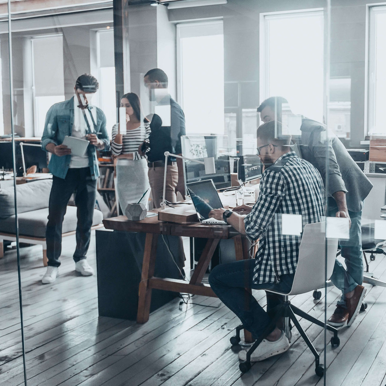 Successful team at work. Group of young business people working and communicating together in creative office