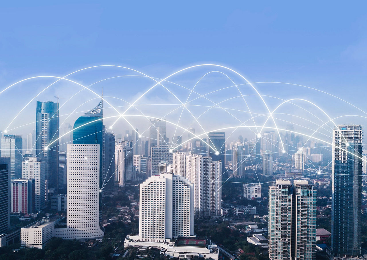 相互接続されたネットワークが描かれたモダンな都市の摩天楼