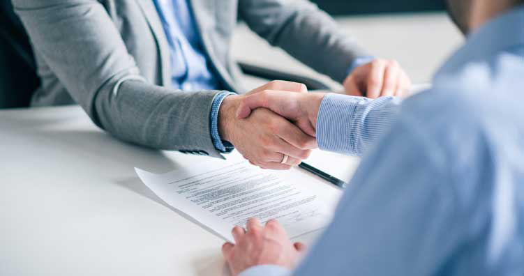 Business partnership concept. Cropped image of two businessmen handshake.