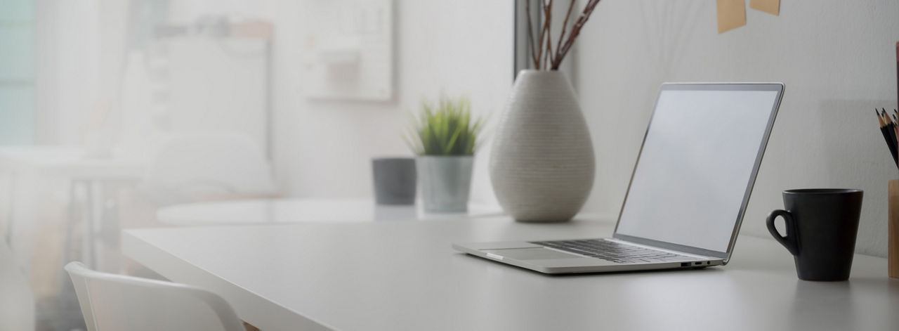 open laptop on top of a modern desk setting