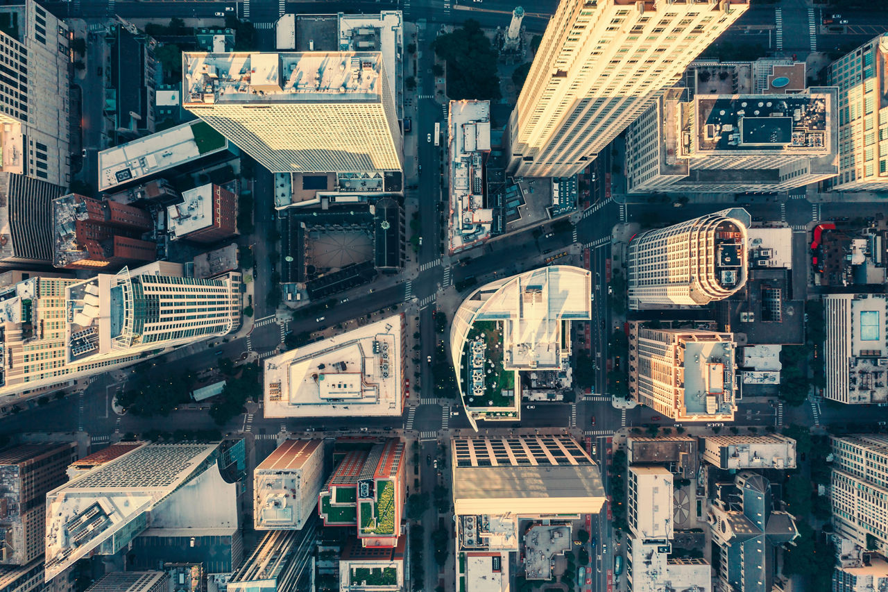 Top down aerial view of Chicago Downtown skyscrapers. Urban grid with streets and tall buildings. Late afternoon light