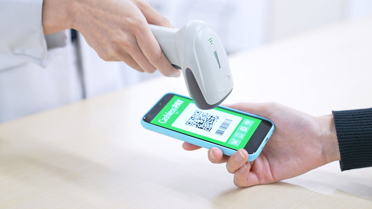 Barcode scanner scanning a QR code on a smartphone