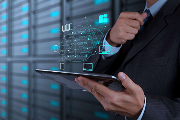 IT professional holding a mobile table in a server room