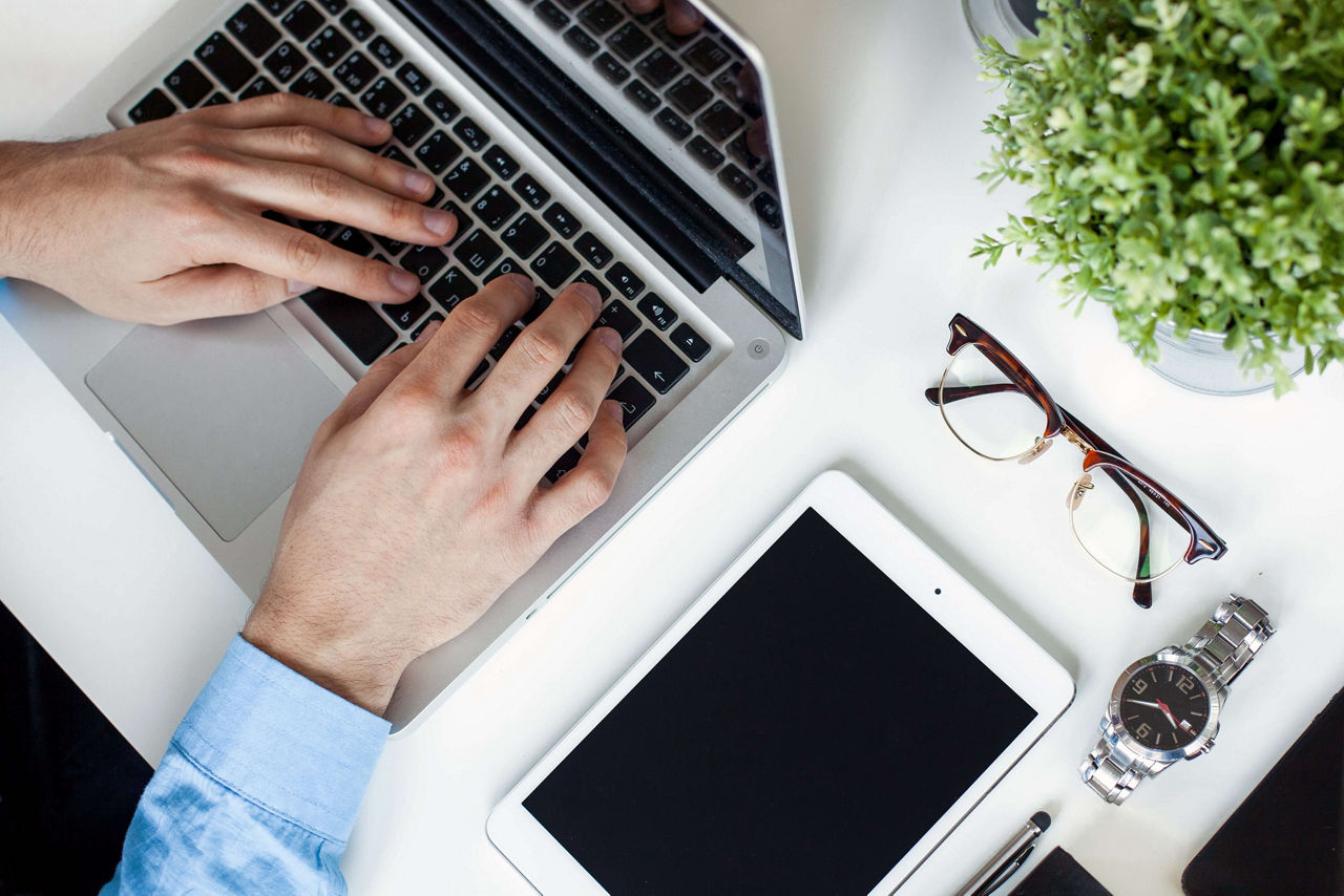 Network professional hands typing on a laptop keyboard