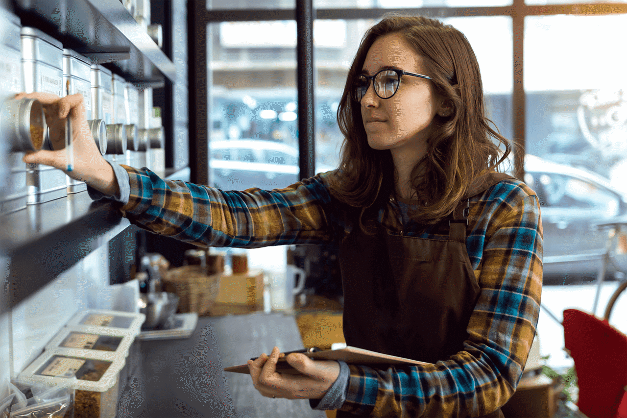 Coffee shop barista taking inventory