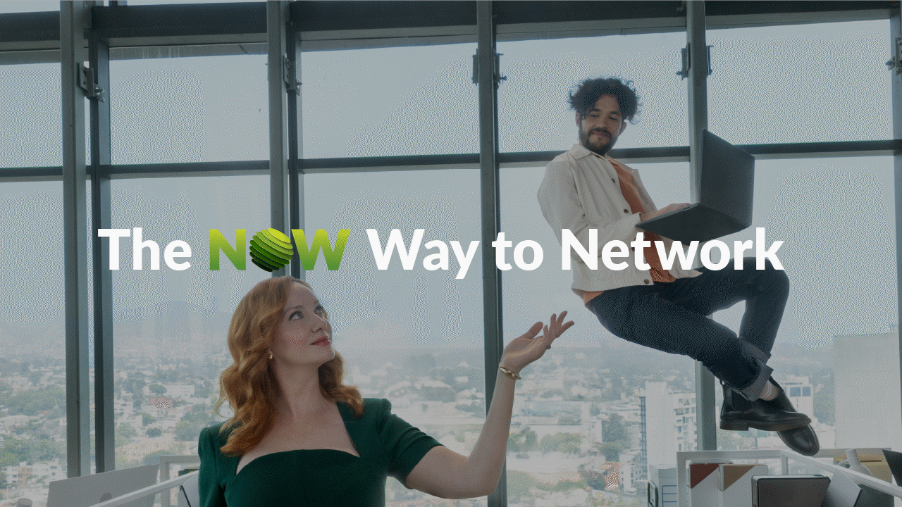 Christina Hendrix smiling in a green dress and elevating an office employee wearing a white shirt, holding a laptop in an office with a city view behind them. Text over the image reads, "The NOW Way to Network."
