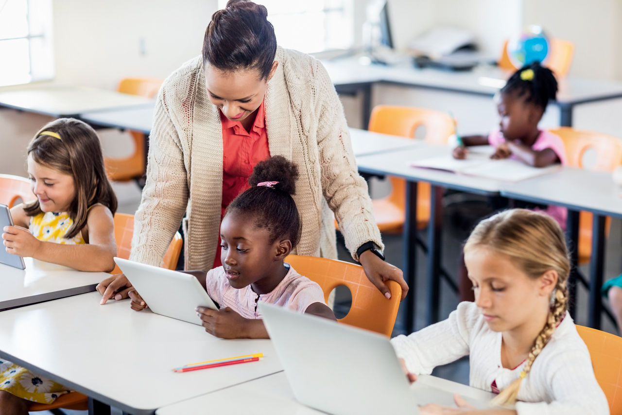 Teacher giving lesson to her students with technology
